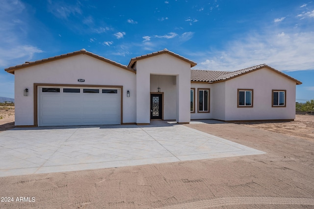 mediterranean / spanish-style house with a garage