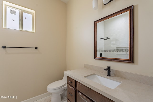 bathroom featuring vanity, toilet, a shower, and tile patterned floors