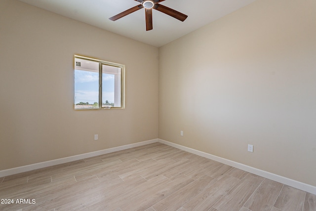 spare room featuring light wood-type flooring and ceiling fan