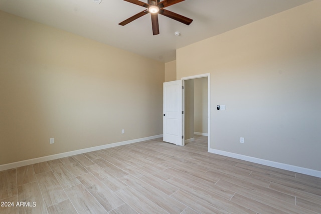 unfurnished room with ceiling fan and light wood-type flooring