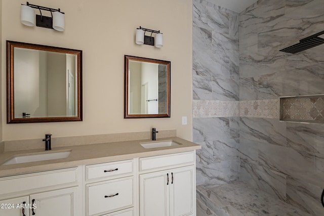 bathroom with vanity and tiled shower