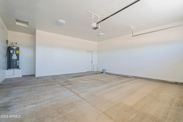 garage with a garage door opener and electric water heater