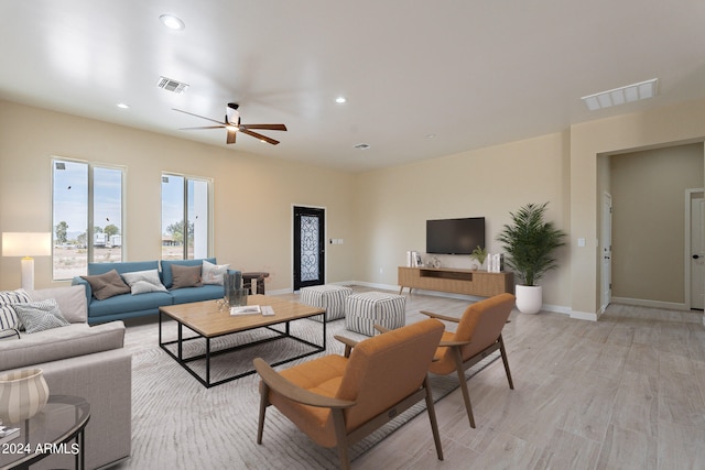 living room featuring light hardwood / wood-style floors and ceiling fan