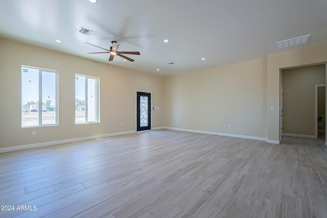 unfurnished living room featuring ceiling fan and light wood-type flooring