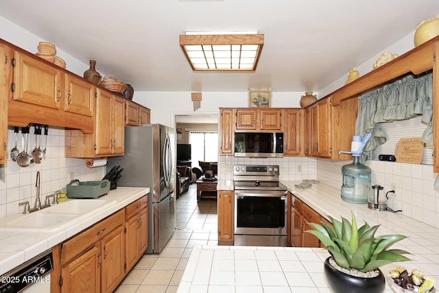 2619 W Lamar Rd, Phoenix, AZ 85017 - kitchen with tile countertops, tasteful backsplash, appliances with stainless steel finishes, and a sink