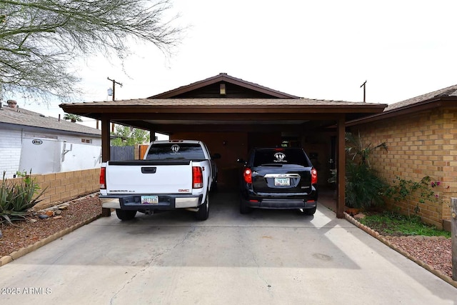 2619 W Lamar Rd, Phoenix, AZ 85017 - view of parking with an attached carport, concrete driveway, and fence