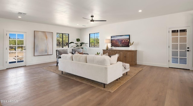 living room featuring hardwood / wood-style flooring, a wealth of natural light, and ceiling fan