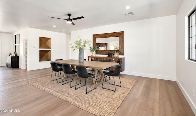 dining area featuring wood-type flooring and ceiling fan