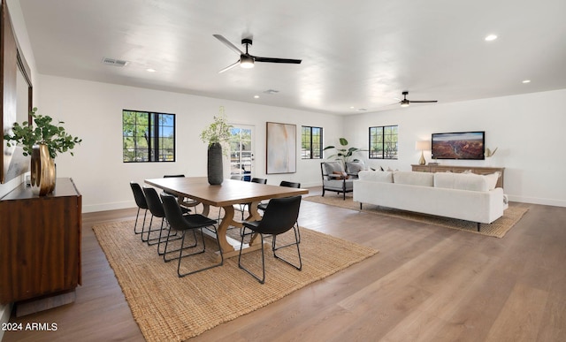 dining space featuring a healthy amount of sunlight, wood-type flooring, and ceiling fan