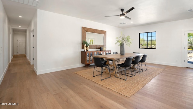 dining space with ceiling fan and hardwood / wood-style flooring