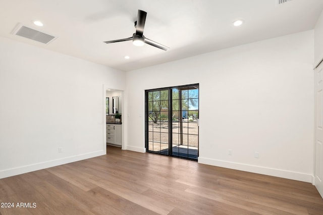 unfurnished room featuring ceiling fan and hardwood / wood-style flooring