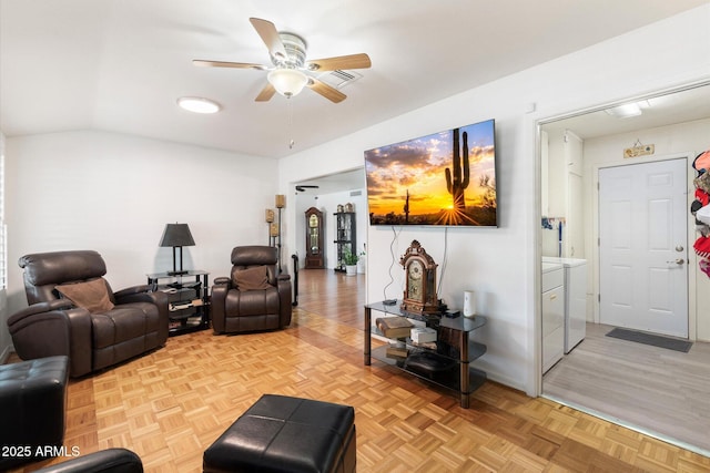 living room featuring separate washer and dryer, ceiling fan, vaulted ceiling, and light parquet floors