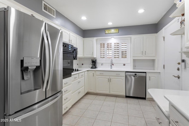 kitchen with stainless steel appliances, sink, and white cabinets