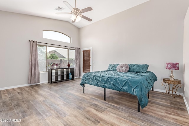 44853 W Jack Rabbit Trl, Maricopa, AZ 85139 - bedroom featuring wood finished floors, lofted ceiling, and a ceiling fan