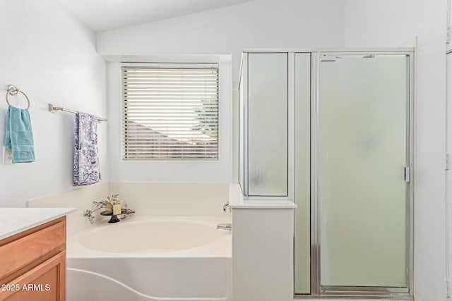 44853 W Jack Rabbit Trl, Maricopa, AZ 85139 - bathroom featuring vanity, a shower stall, a garden tub, and vaulted ceiling