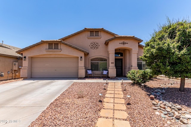44853 W Jack Rabbit Trl, Maricopa, AZ 85139 - mediterranean / spanish house with stucco siding, driveway, and a garage