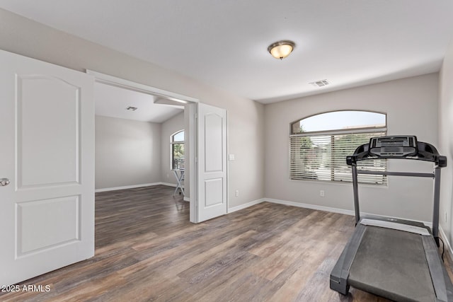 44853 W Jack Rabbit Trl, Maricopa, AZ 85139 - exercise room featuring wood finished floors and baseboards
