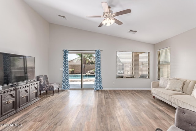 44853 W Jack Rabbit Trl, Maricopa, AZ 85139 - living area featuring vaulted ceiling, light wood finished floors, and a ceiling fan