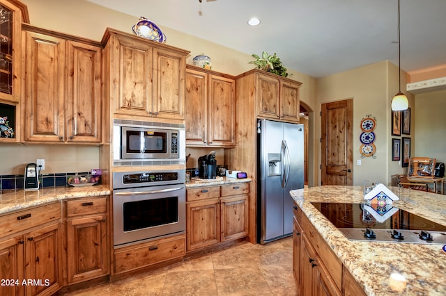 kitchen featuring stainless steel appliances, decorative light fixtures, light stone countertops, and light tile patterned floors