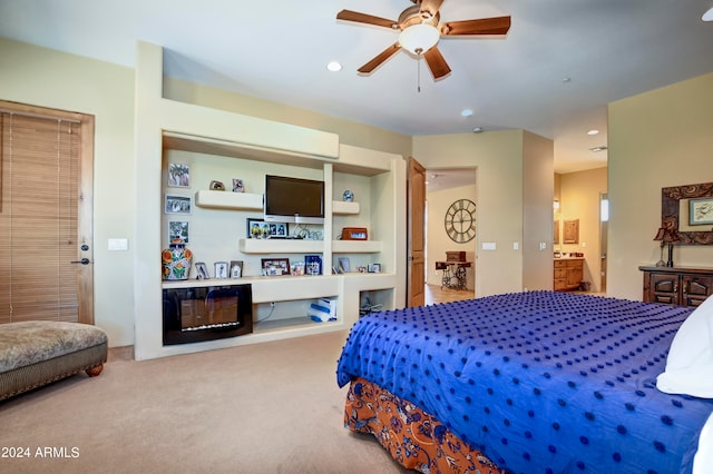 carpeted bedroom with connected bathroom and ceiling fan