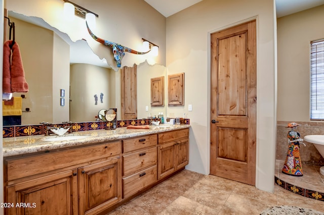 bathroom featuring tile patterned floors, a tub, and double sink vanity