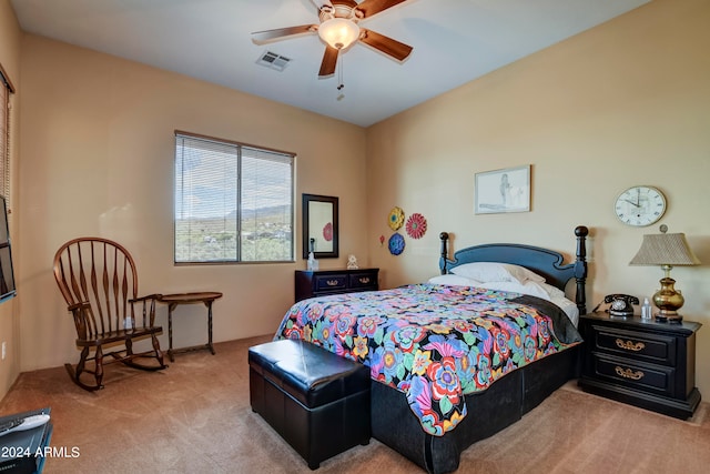 bedroom with ceiling fan and light colored carpet