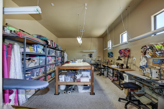 office featuring carpet flooring, a healthy amount of sunlight, and a towering ceiling