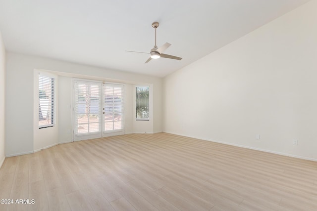 empty room featuring light wood-type flooring, ceiling fan, and lofted ceiling