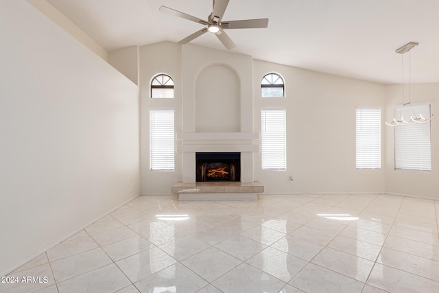 unfurnished living room featuring a fireplace and ceiling fan with notable chandelier