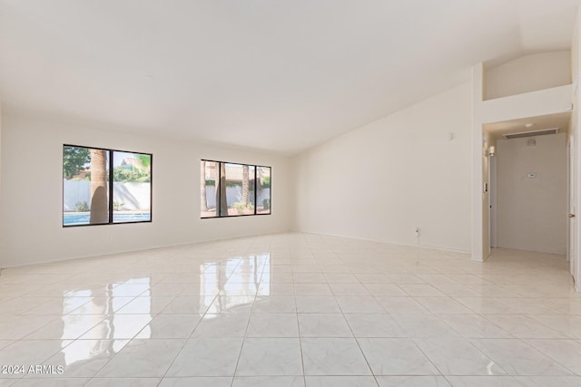 spare room featuring plenty of natural light and lofted ceiling