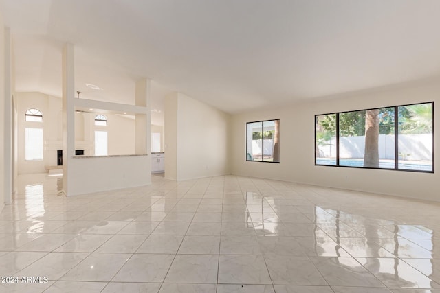 unfurnished room featuring lofted ceiling