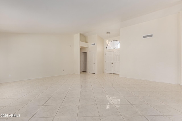 unfurnished room with a high ceiling