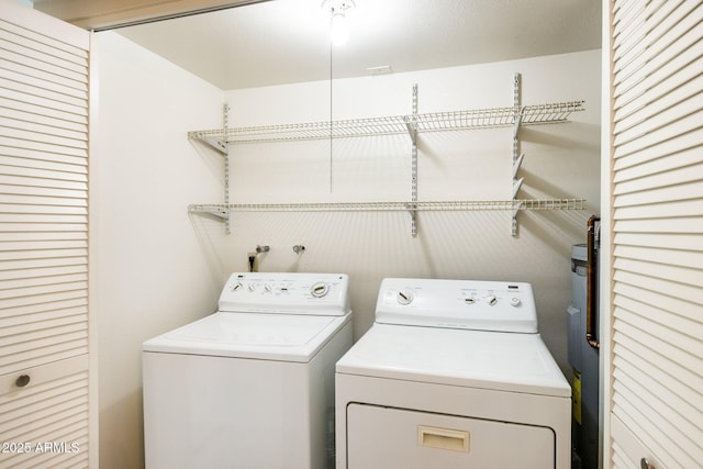 clothes washing area featuring independent washer and dryer