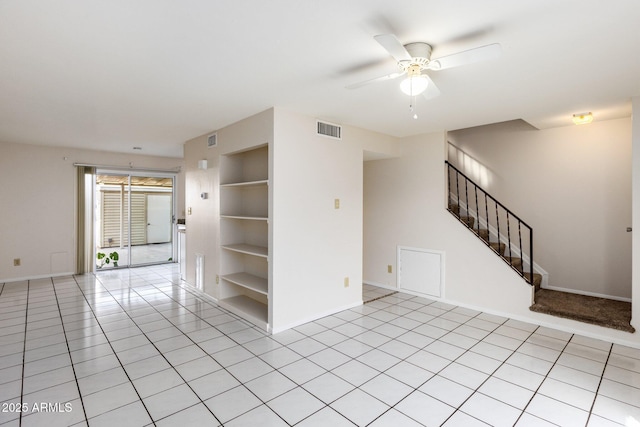 unfurnished room with light tile patterned floors, ceiling fan, and built in shelves