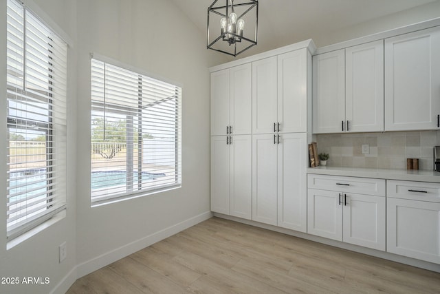 interior space featuring a chandelier and light hardwood / wood-style floors