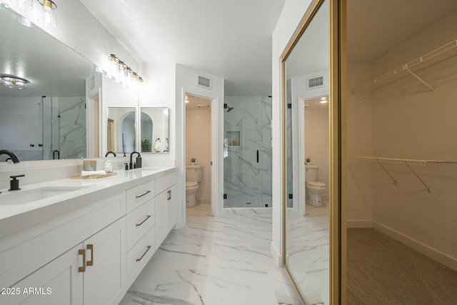 bathroom featuring toilet, a shower with door, and a textured ceiling