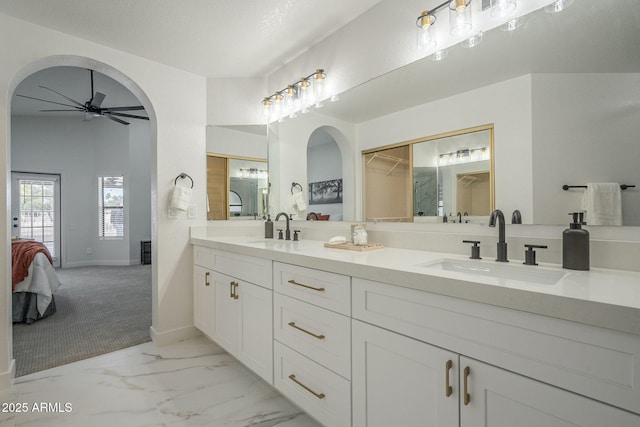 bathroom featuring ceiling fan, vanity, and a textured ceiling