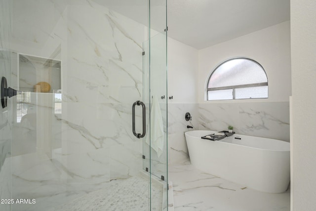 bathroom featuring separate shower and tub