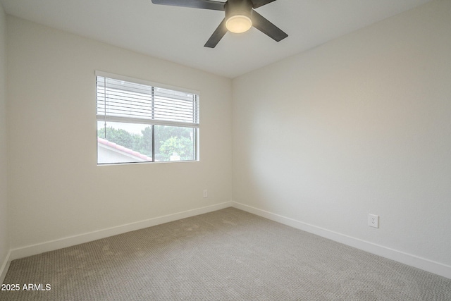 spare room featuring ceiling fan and carpet flooring