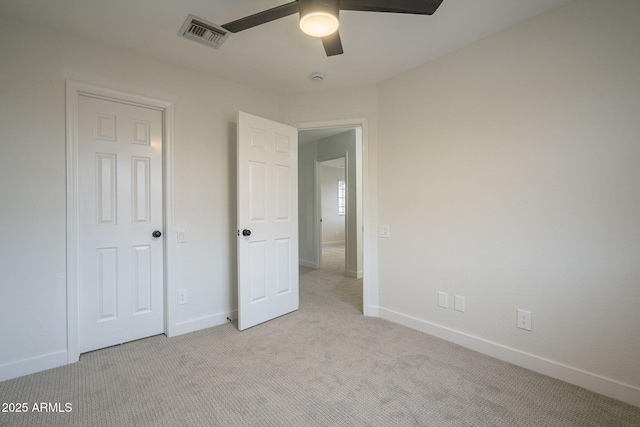 unfurnished bedroom with light colored carpet and ceiling fan