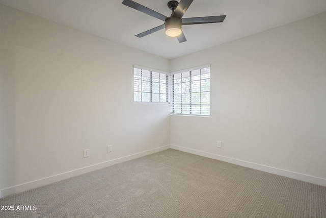 empty room featuring carpet flooring and ceiling fan