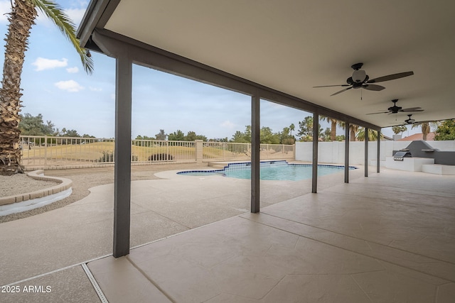 view of pool with a patio area, ceiling fan, and an outdoor kitchen