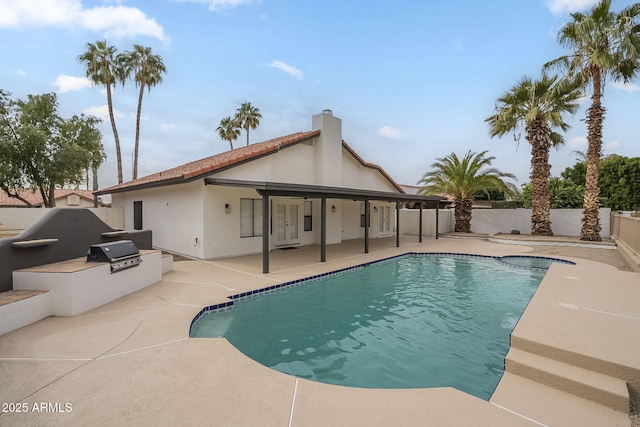 view of pool with area for grilling and a patio area