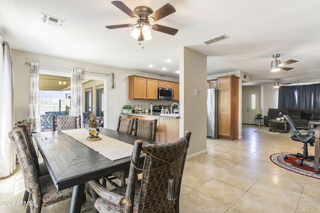 tiled dining room featuring ceiling fan