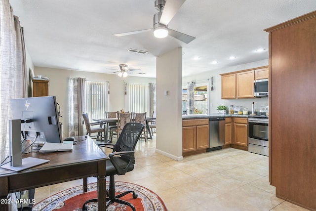 kitchen featuring appliances with stainless steel finishes, a wealth of natural light, ceiling fan, and light tile patterned floors