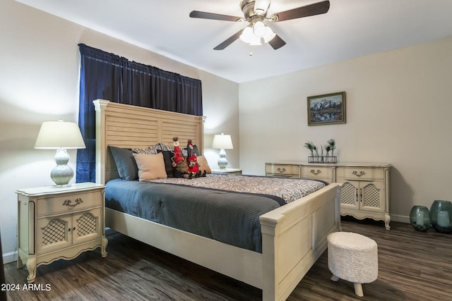 bedroom with dark hardwood / wood-style flooring and ceiling fan