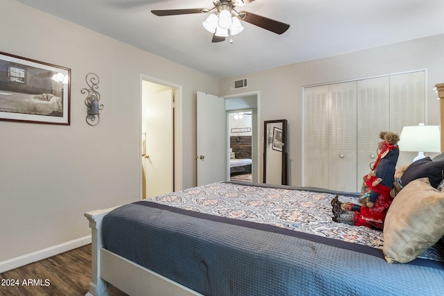 bedroom with dark wood-type flooring, ceiling fan, and a closet