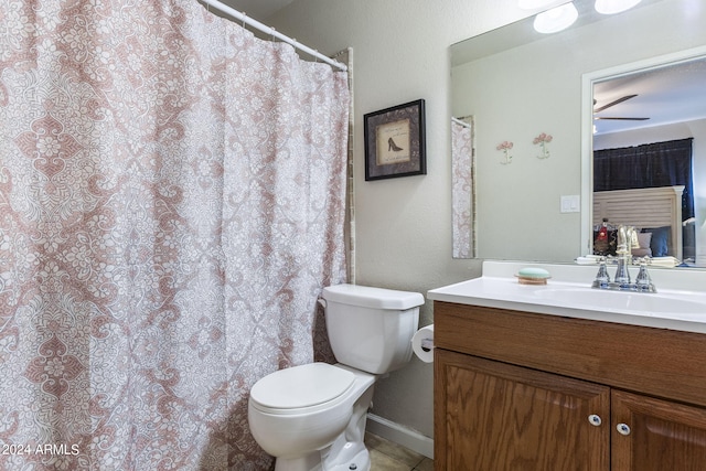 bathroom featuring tile patterned flooring, vanity, and toilet