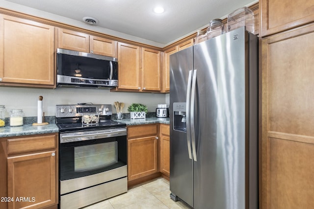 kitchen featuring light tile patterned floors and appliances with stainless steel finishes