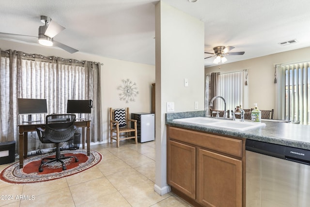 kitchen with sink, stainless steel dishwasher, ceiling fan, and light tile patterned flooring